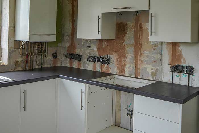 Dirty kitchen with exposed wiring